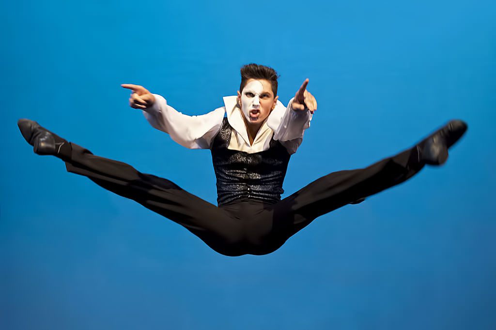dancer leaping blue background nsw
