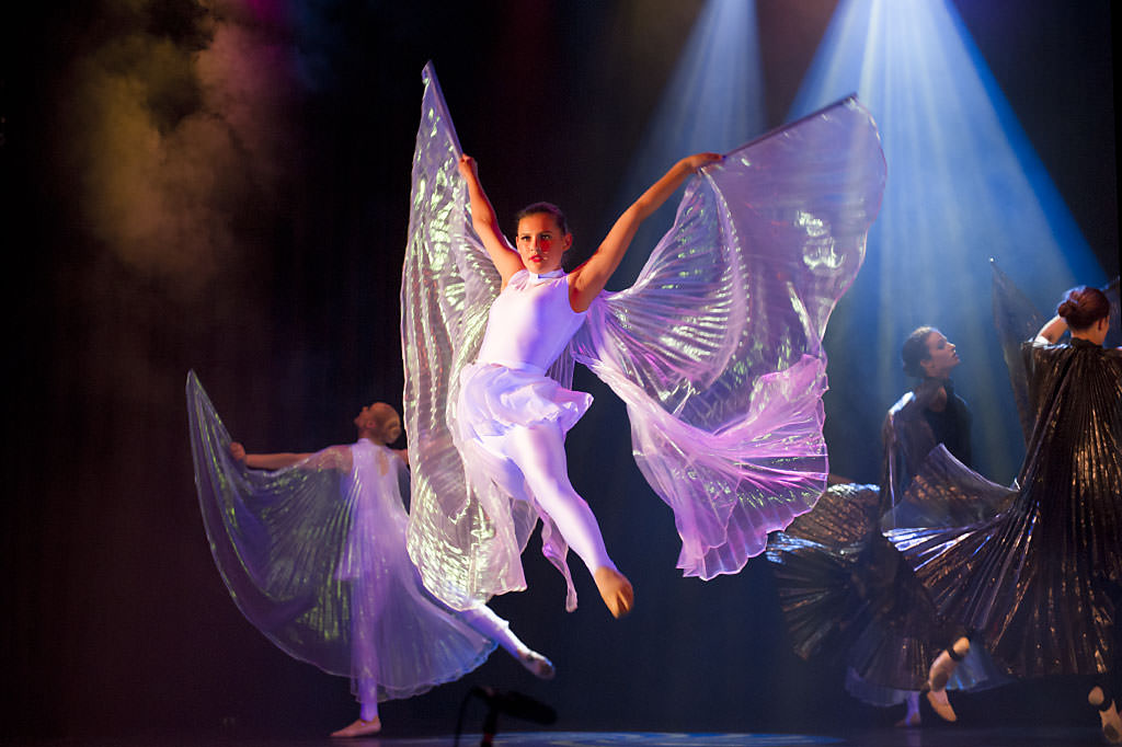 dancers in costumes on stage